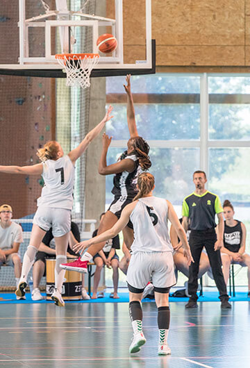 basketball player Karla is blocking another player during shooting