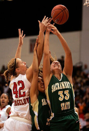 basketball players where Karla in white UNLV jersey is blocking opposite player from sacramento state